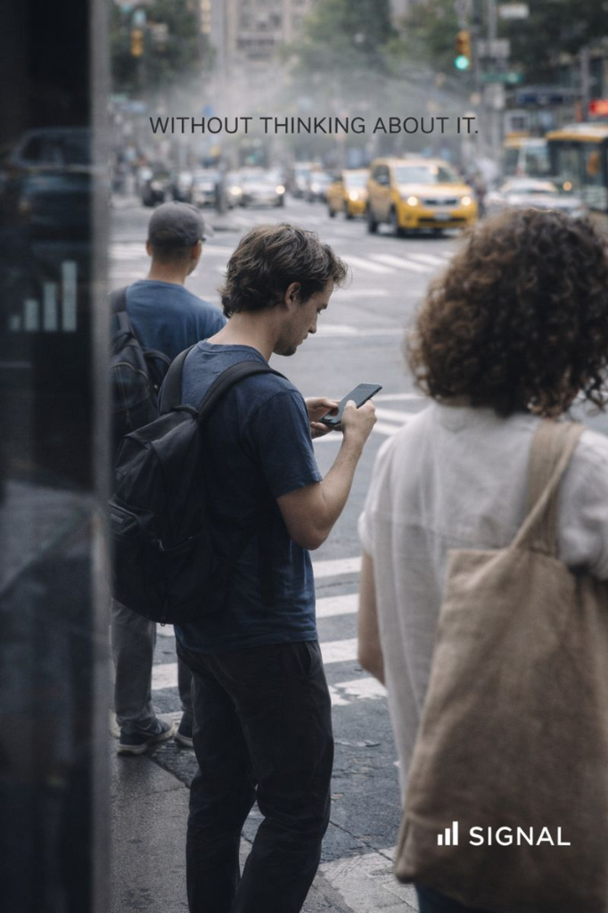 Avenue lifestyle photography showing a man using a smartphone with Signal branding overhead